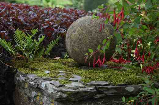 Sometimes shabby chic works in the garden as well as in the home. A moist, mild climate creates the sort of combination of moss and fern that makes stone,  berberis and fuchsia not just nice but beautiful