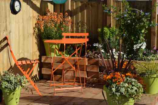 The Relaxation Garden. I love the way the flowers pick up the colour of the furniture but orange is not the most relaxing colour